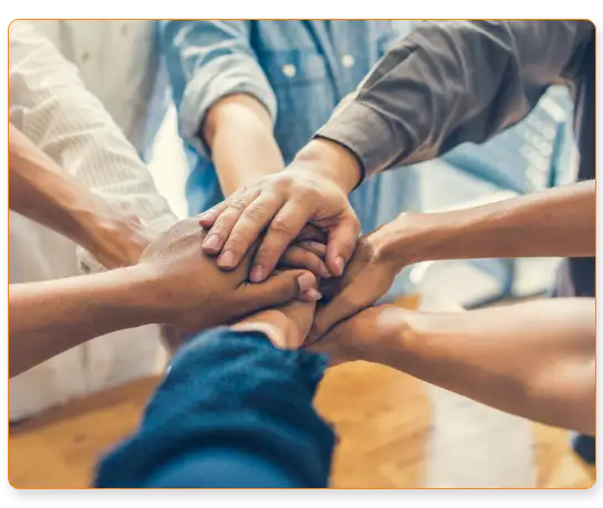 Deepwatch team members putting their hands together